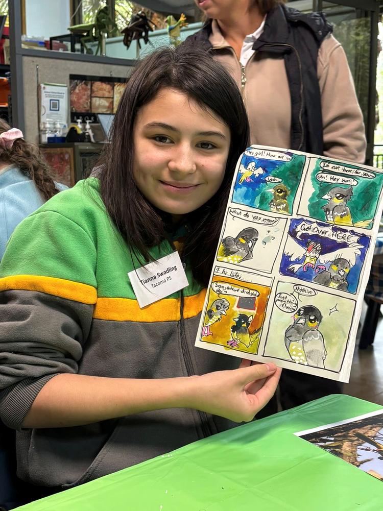 A student holding her artwork.